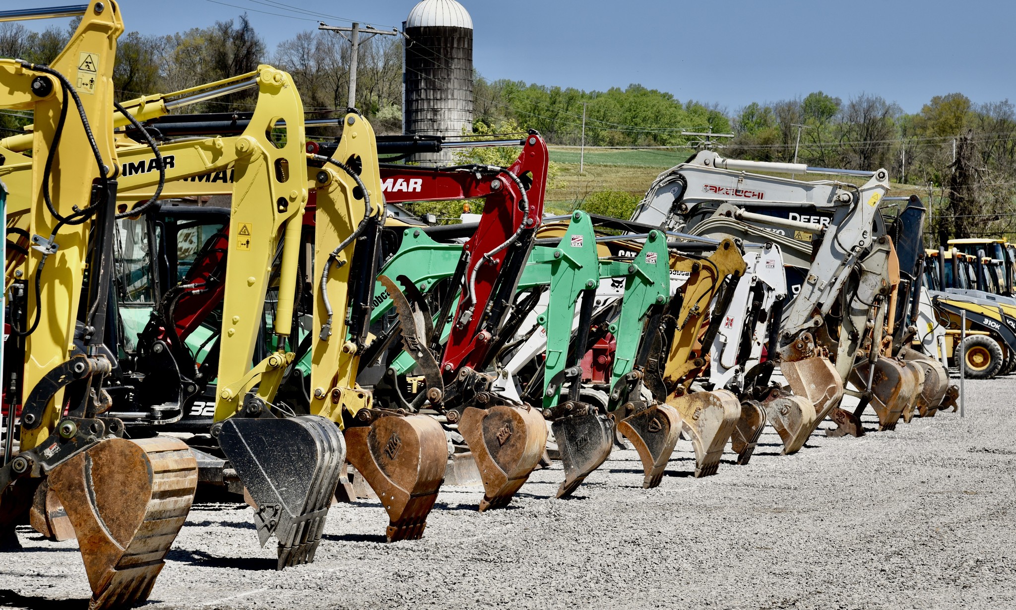 multiple excavators lined up in a row