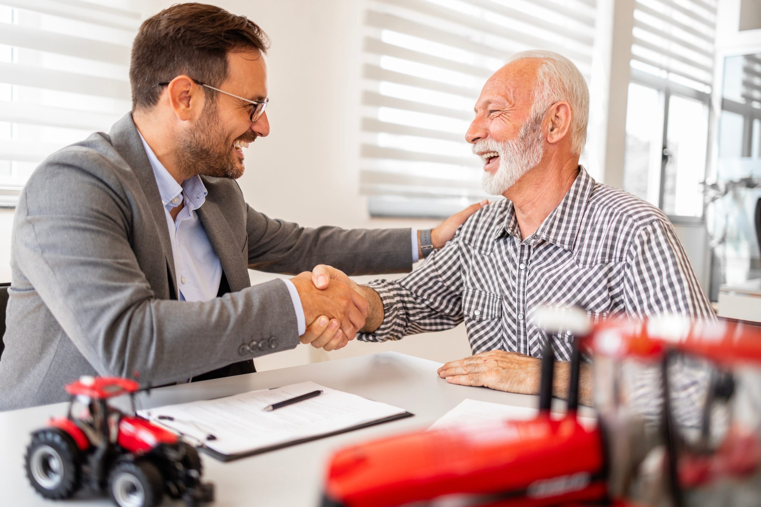 professional person in a suit shaking hands with a client during a business meeting