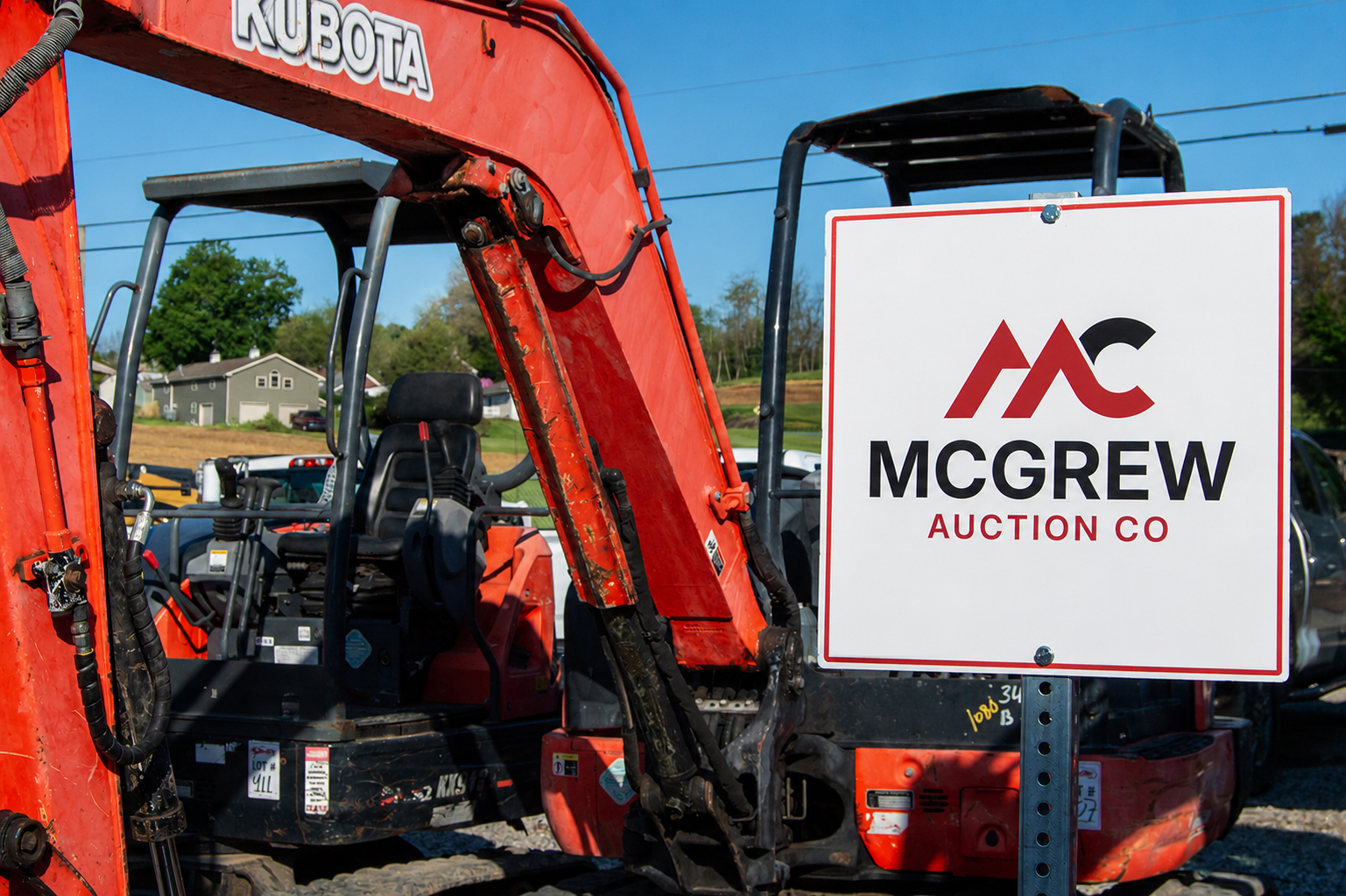 McGrew Auction Co. Sign in-front of Kubota Mini Excavators