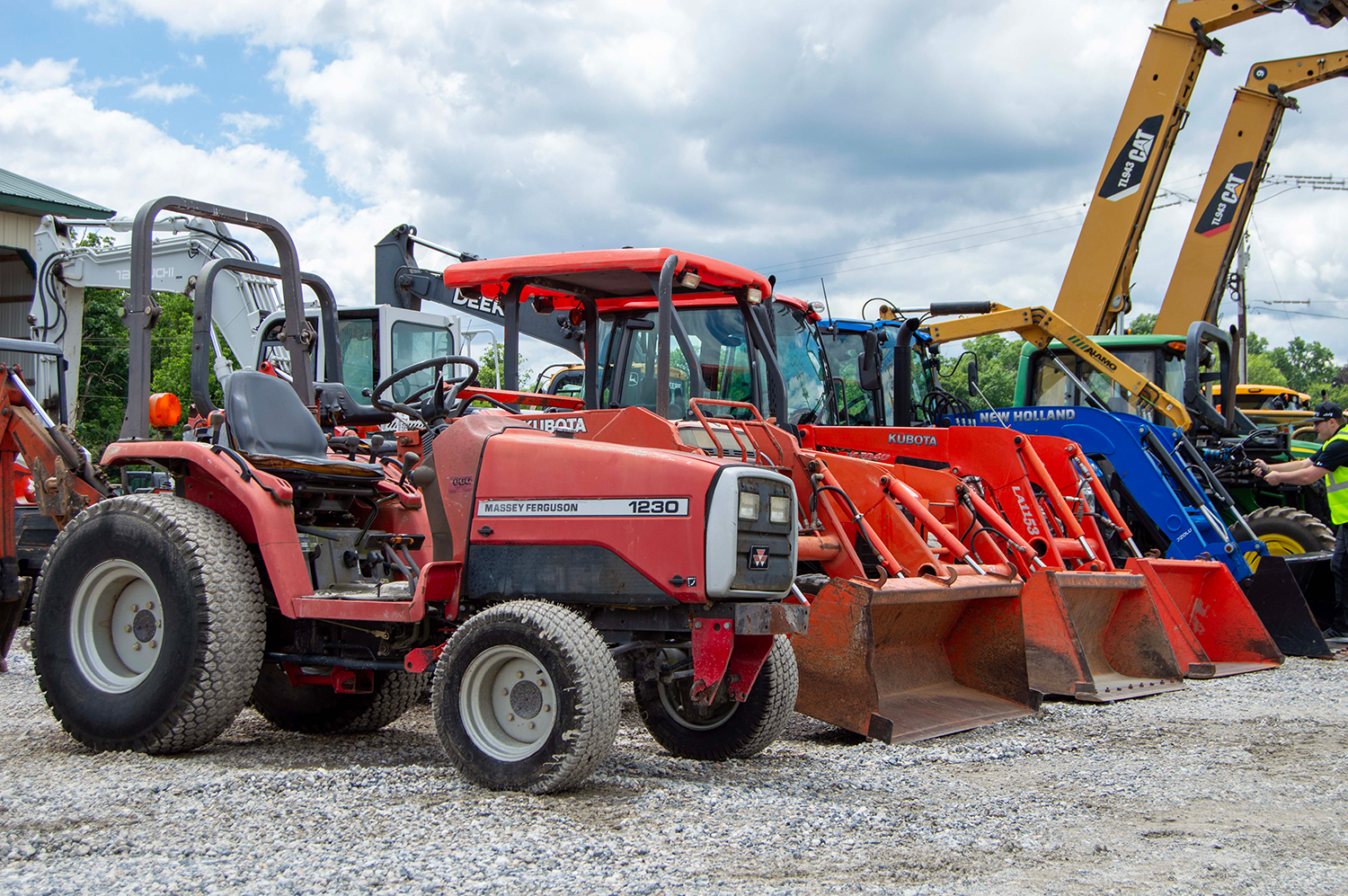 Used Tractors & Wheel Loaders Lined Up on Auction Lot