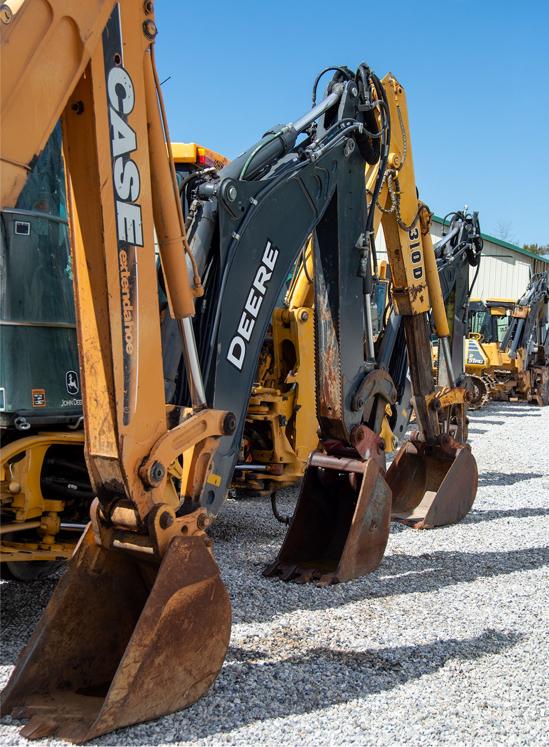 Used Excavator Lineup On Auction Lot